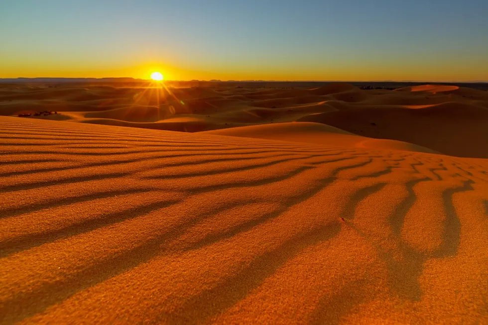 Camel trekking at sunset in the Sahara dunes – Fes to Marrakech desert tour 3 days